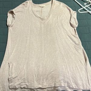 A pink tee. V neck with folded sleeves. Extra long with slits on each side.
